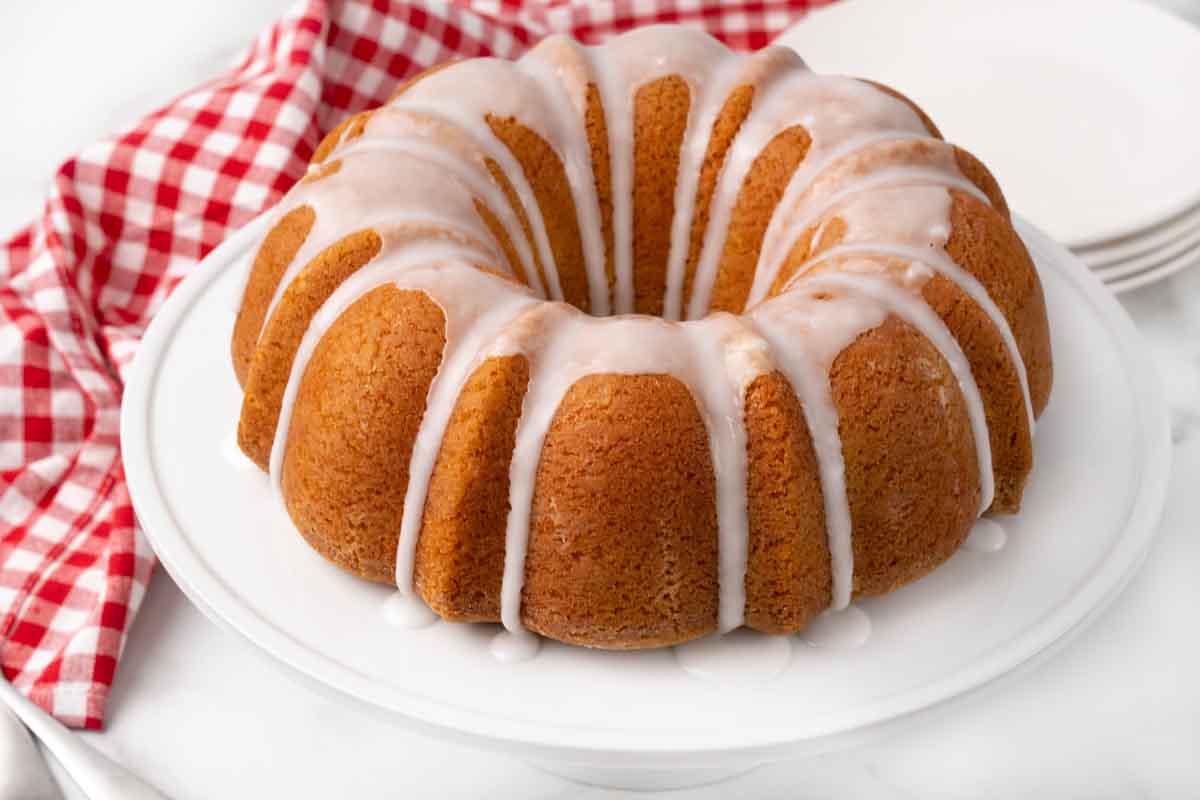 Whole 7-up cake on a white platter.