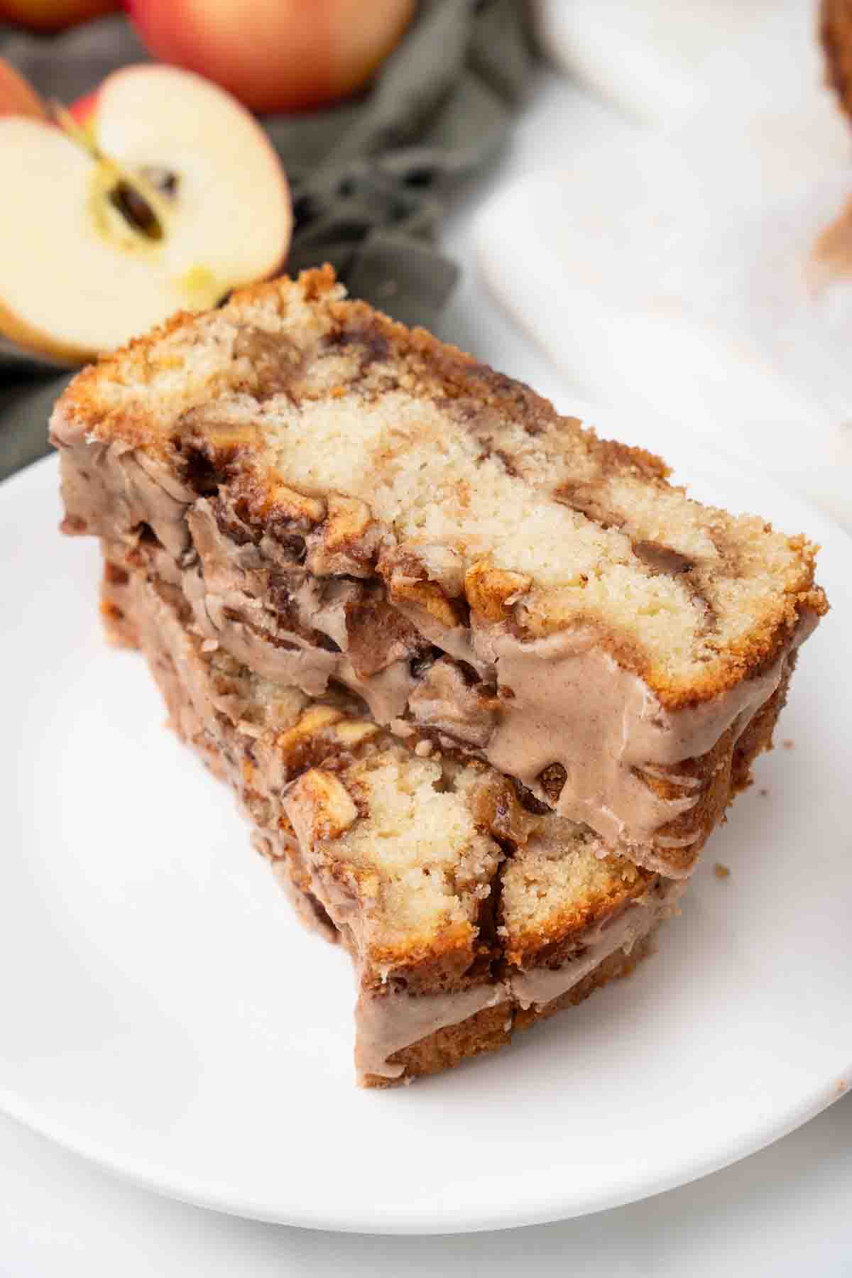 two slices of apple fritter bread on a white cutting board.