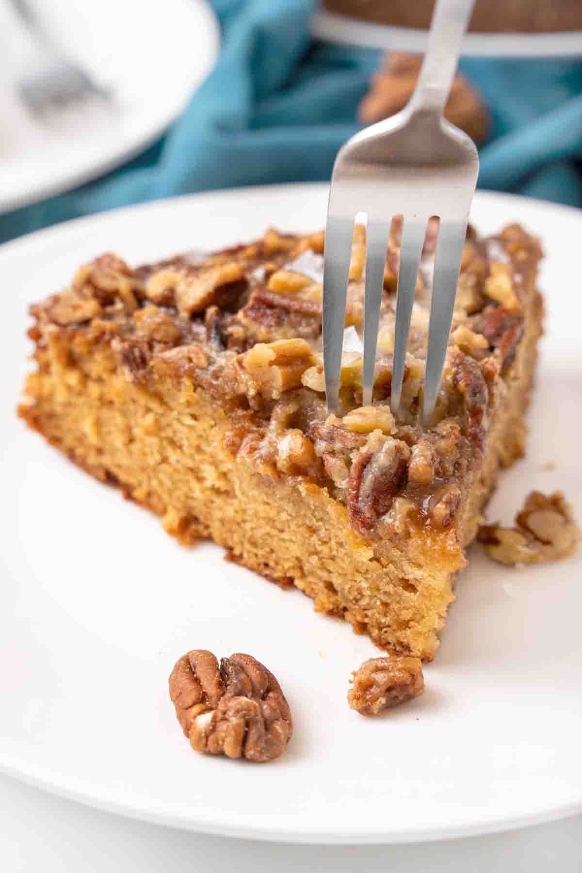 Slice of buttermilk cake on a white plate with a fork in it.