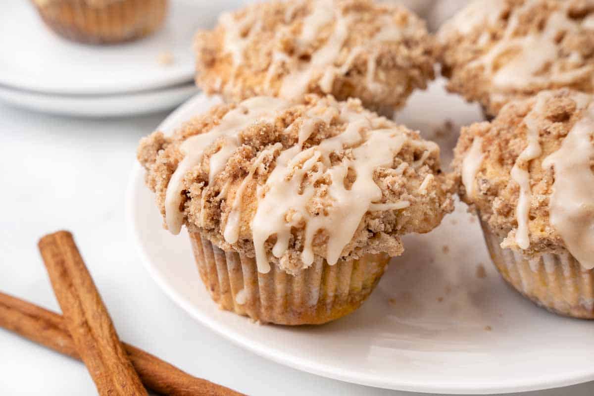 Coffee cake muffins on a white plate.