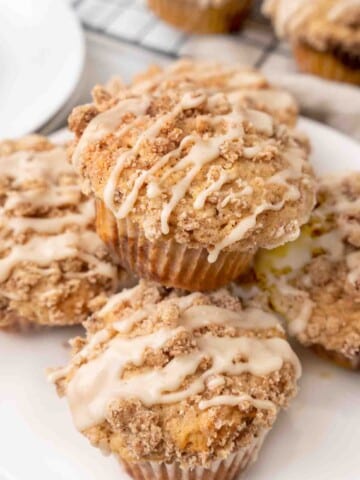 Coffee cake muffins on a white plate.