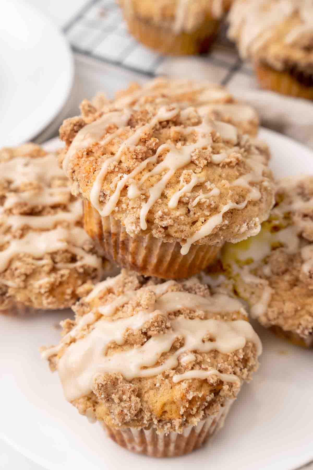 Coffee cake muffins on a white plate.