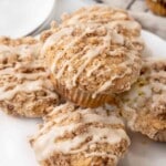 Coffee cake muffins on a white plate.