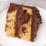 Slice of marble cake on a white plate.