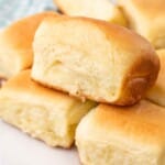 Parker house rolls on a white parchment paper.