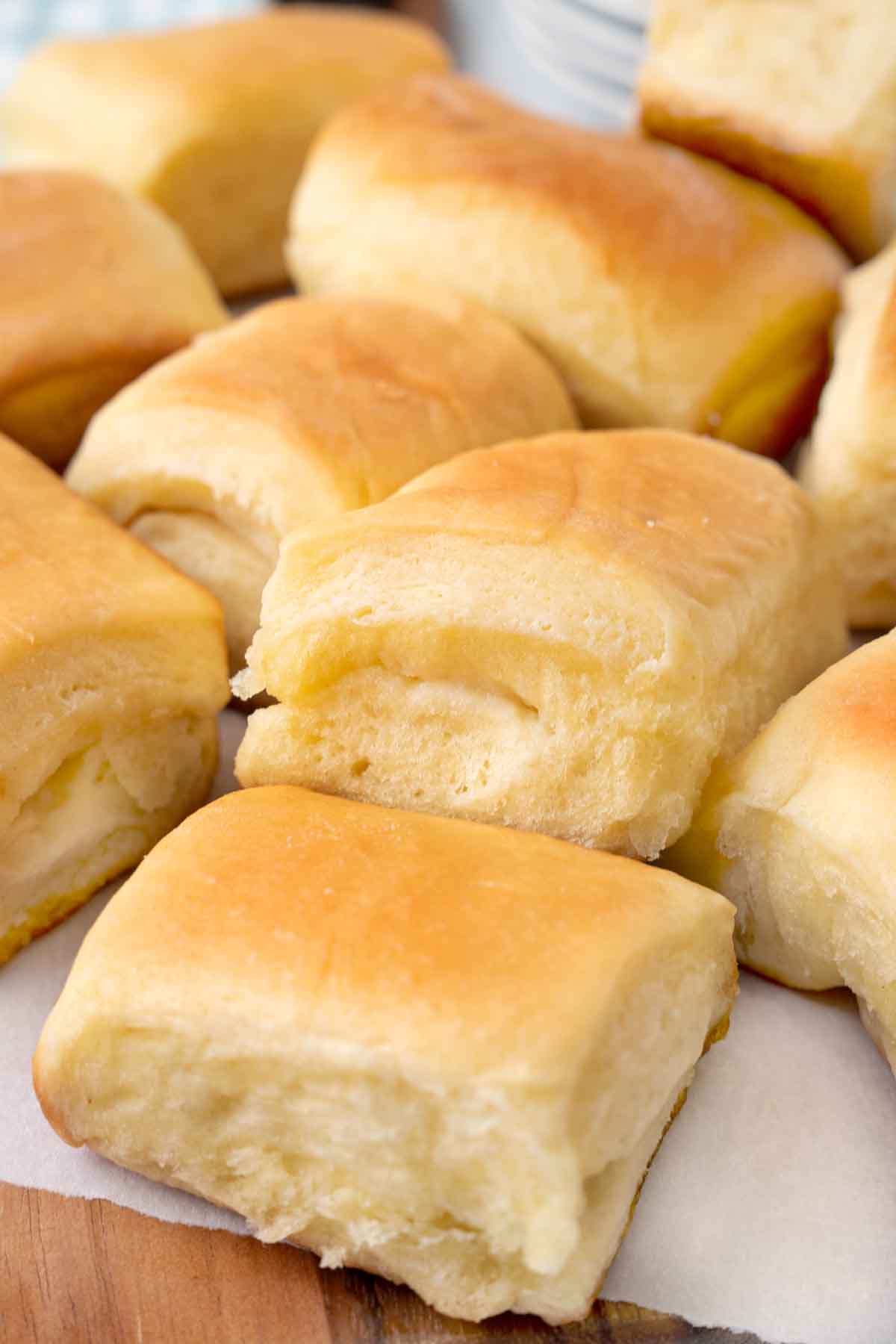 Parker house rolls on a white parchment paper.