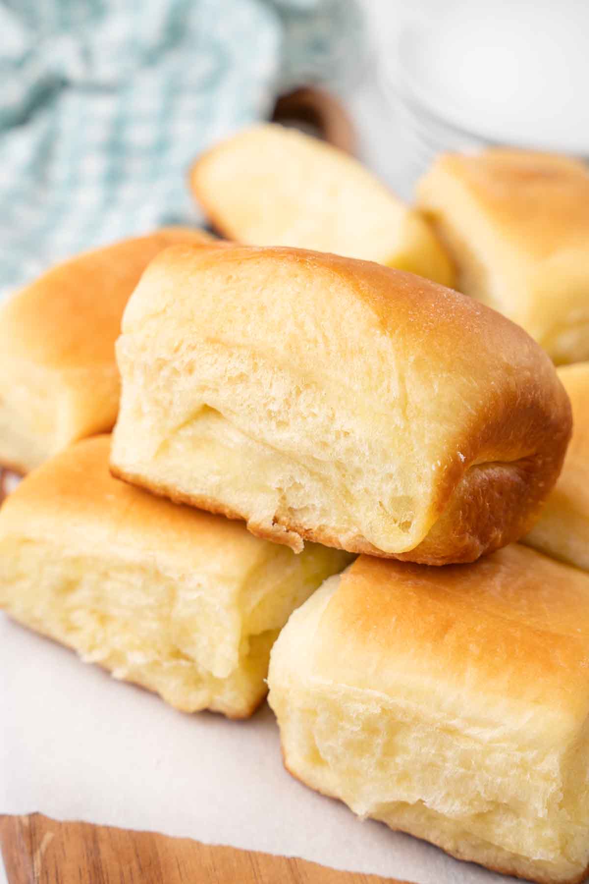 Parker house rolls on a white parchment paper.