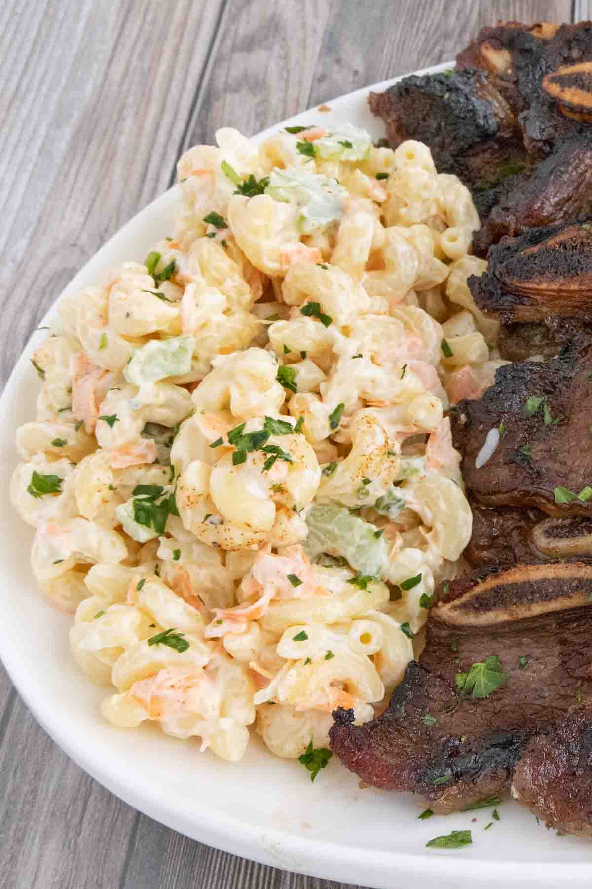 Hawaiian macaroni salad with ribs on a white plate.